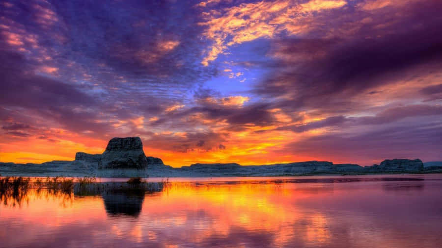 Majestic Sunset Over A Tranquil Landscape Wallpaper