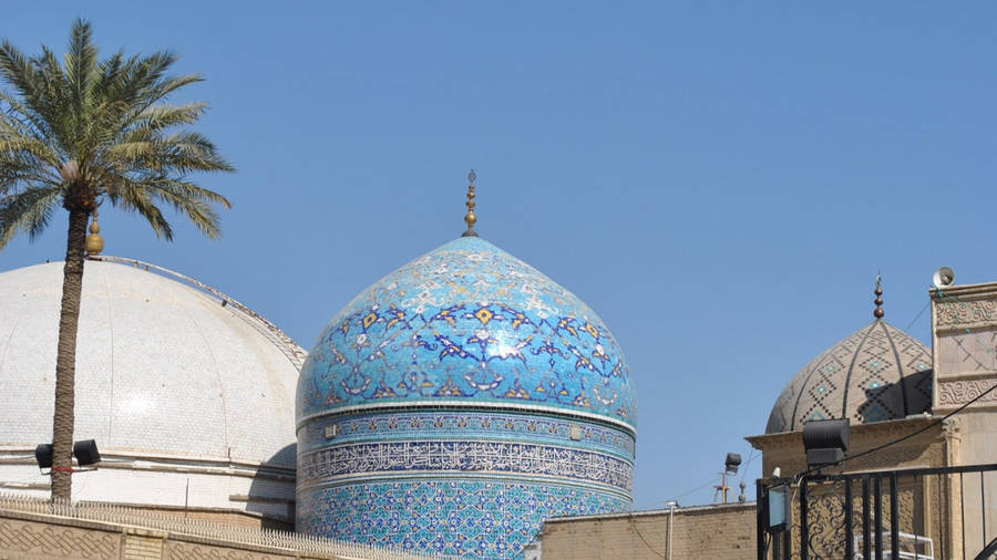 Majestic View Of The Blue Mosque Dome In Baghdad Wallpaper