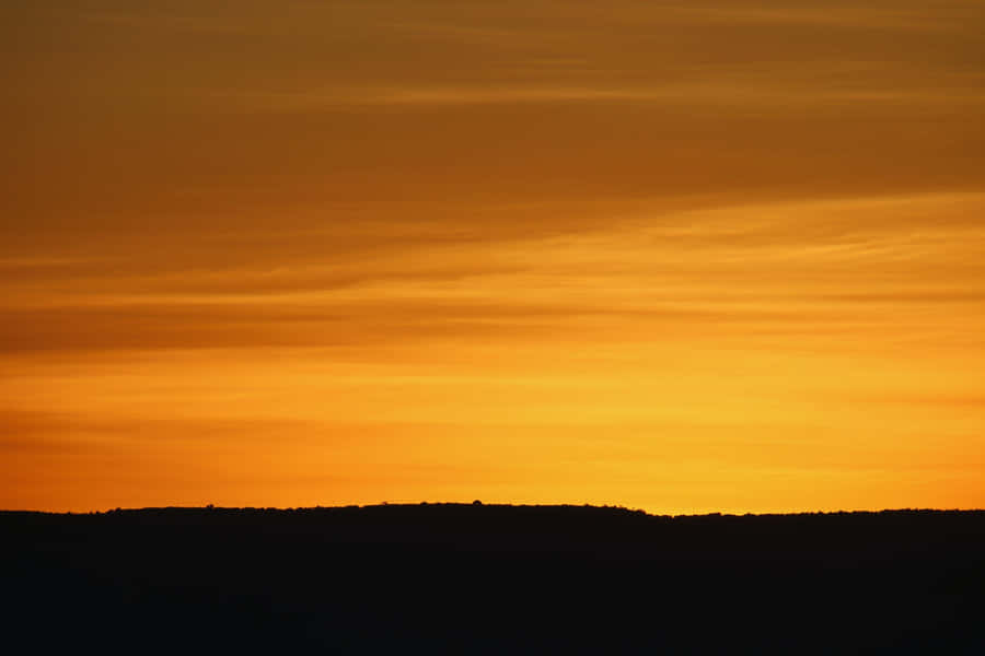 Majestic Yellow Sky At Sunset Wallpaper