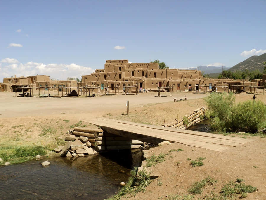 Makeshift Bridge Over Taos Pueblo River Wallpaper
