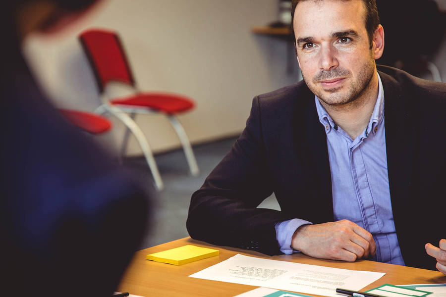 Male Teacher Listening To Parents Wallpaper
