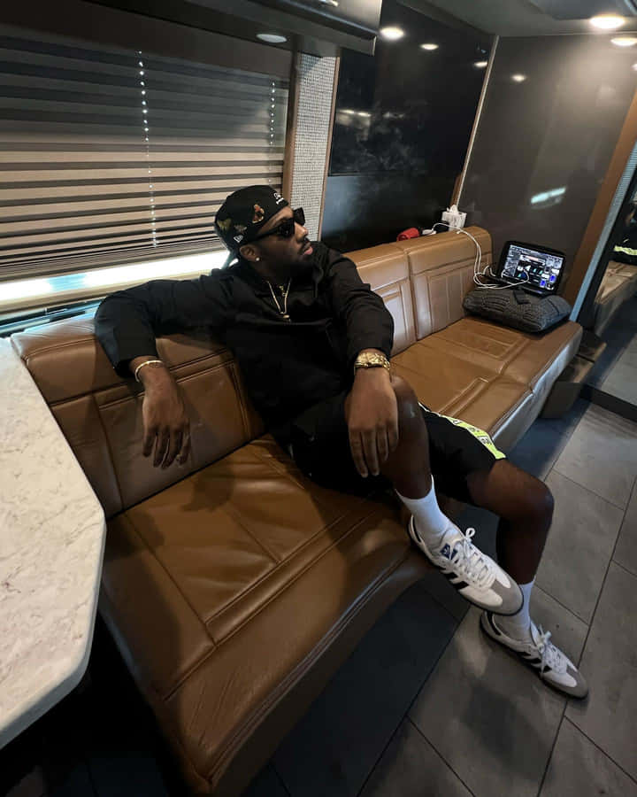 Man Chillingin Luxury R V Lounge Wallpaper