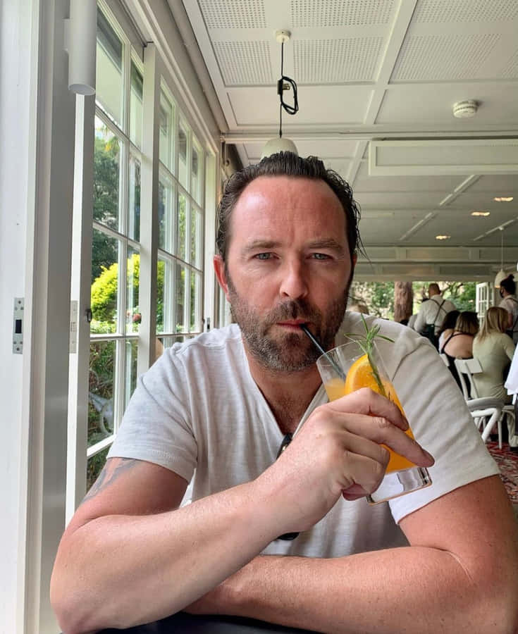 Man Drinking Cocktailat Cafe Wallpaper