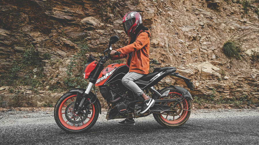 Man Driving A Ktm Duke 200 Wallpaper