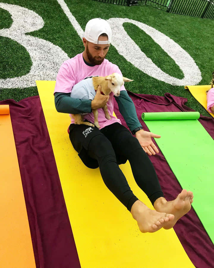 Man Holding Goaton Yoga Mat Wallpaper