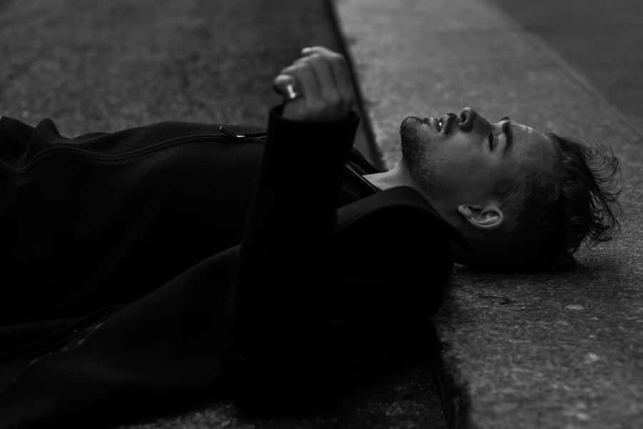 Man Lyingon Ground Blackand White Wallpaper