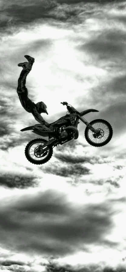 Man On Motorcycle In Sky [wallpaper] Wallpaper