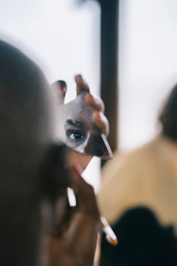 Man Reflected On Glass In Sierra Leone Wallpaper