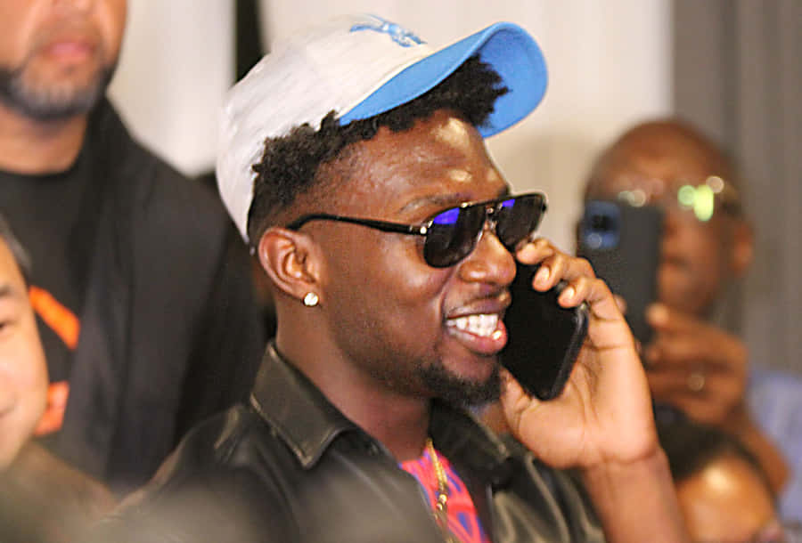 Man Smiling While Talkingon Phone Wallpaper