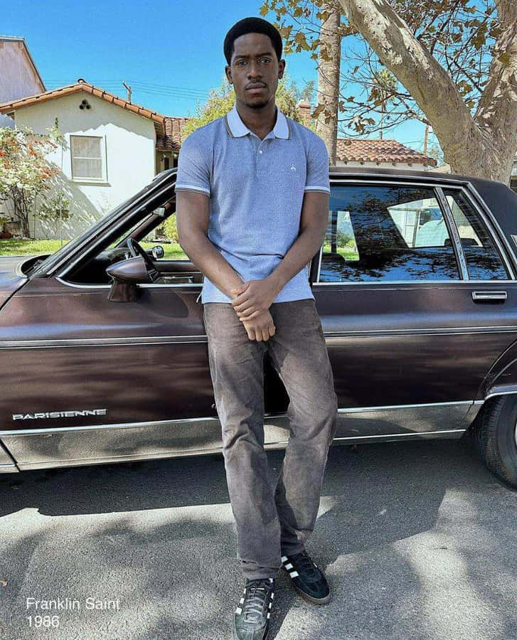 Man Standing By Vintage Car1986 Wallpaper