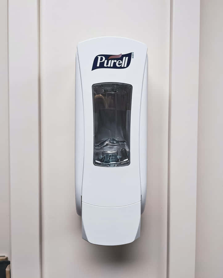 Man Using Antiseptic Solution For Hand Hygiene Wallpaper