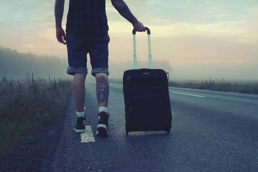 Man Walking With Suitcase On Road Dawn Wallpaper