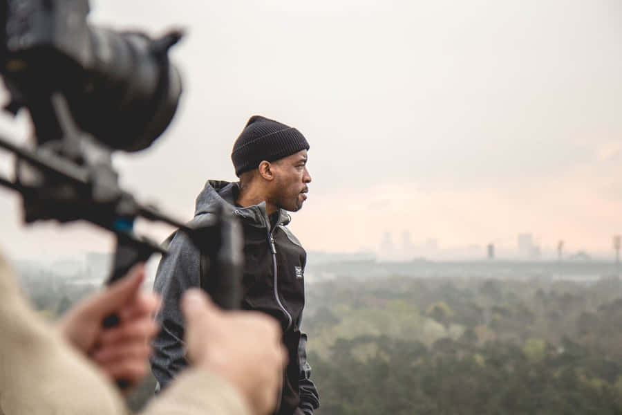 Manin Beanie Looking Away During Filming Wallpaper