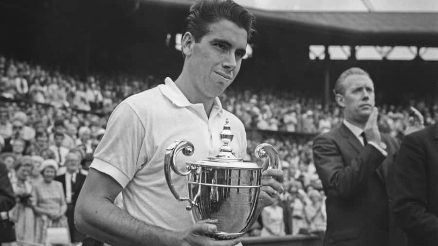 Manuel Santana Holding His Trophy After Winning Wallpaper
