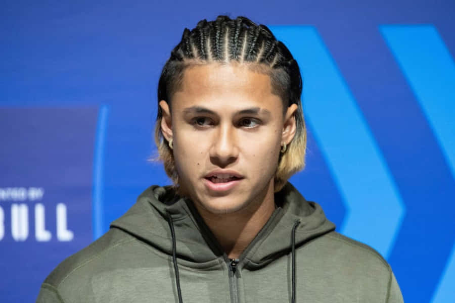 Manwith Braided Hairstyleat Event Wallpaper