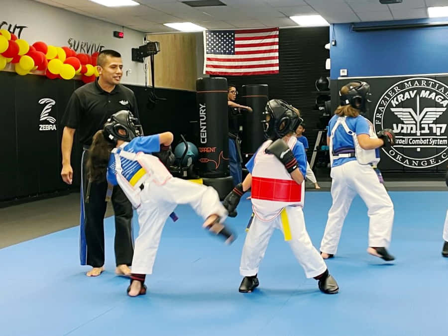 Martial Arts Students Demonstrating Techniques In Uniforms Wallpaper