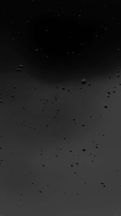 Matte Blacki Phonewith Water Droplets Wallpaper