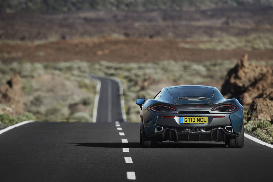 Mclaren 570 Gt In Road Wallpaper