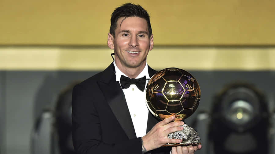 Messi Holding His Seventh Ballon D'or Trophy Wallpaper