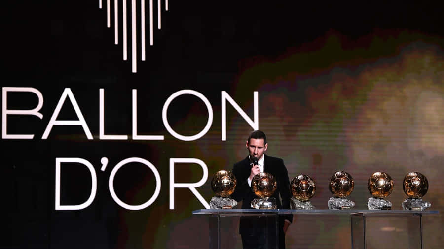 Messi Holding The Ballon D'or Award Wallpaper