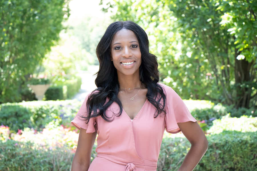 Mia Love Gracefully Posing In A Garden Wallpaper