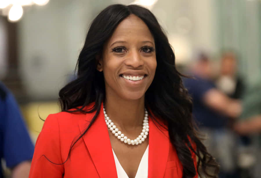 Mia Love Smiling In Red Coat Wallpaper