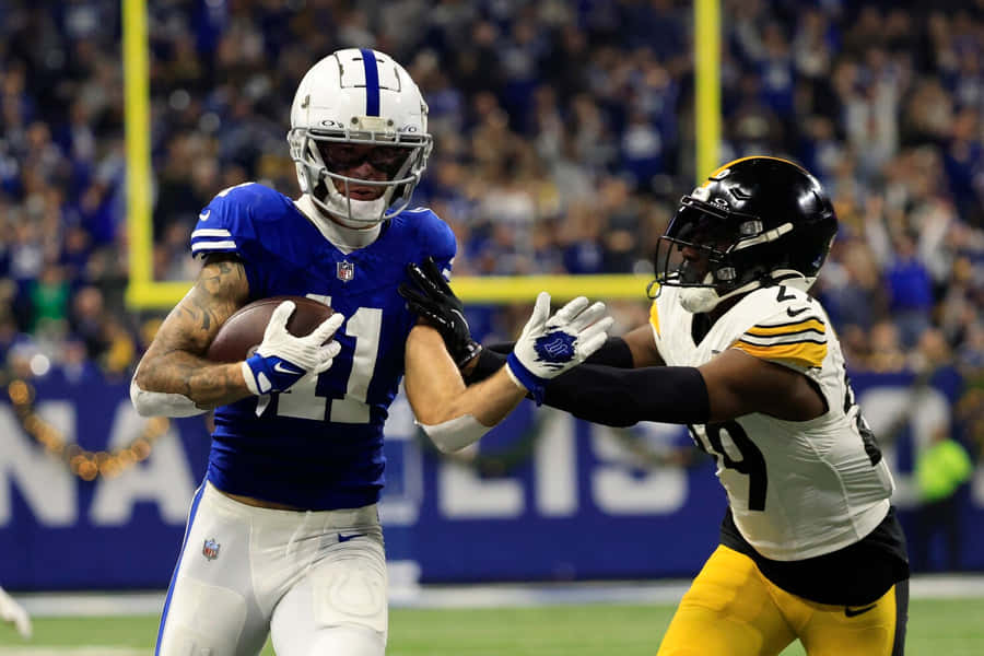 Michael Pittman Jr Evading Tackle During Game Wallpaper