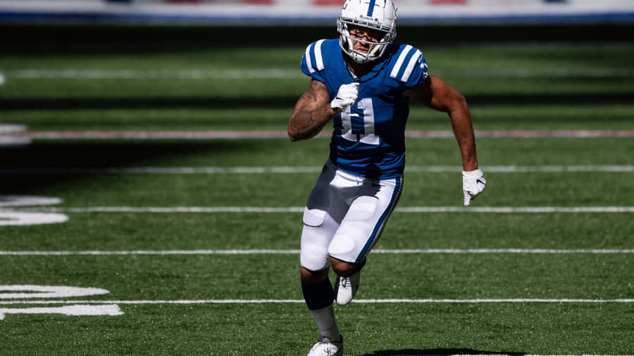 Michael Pittman Jr Runningon Field Wallpaper