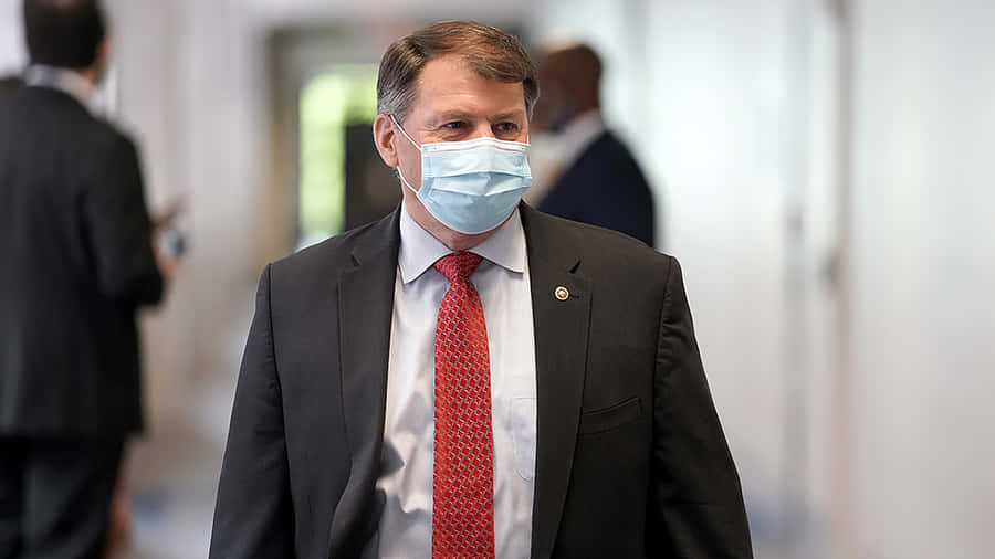 Michael Rounds Delivering A Powerful Speech At An Event. Wallpaper