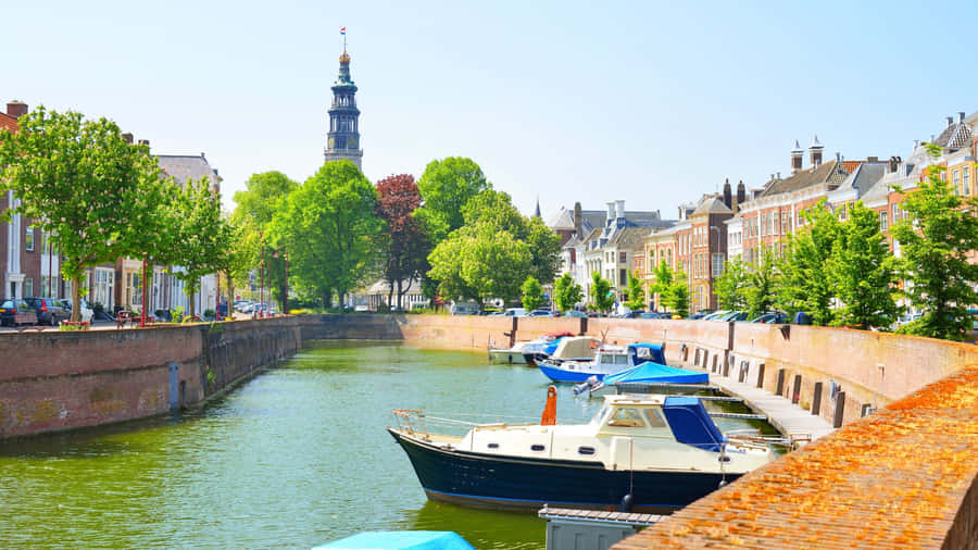 Middelburg Canal Viewwith Boatsand Tower Wallpaper