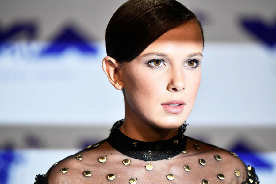 Millie Bobby Brown Radiating Beauty In Her Signature Style Wallpaper