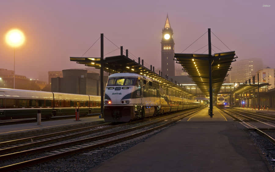 Misty Dawn Train Station Scene Wallpaper