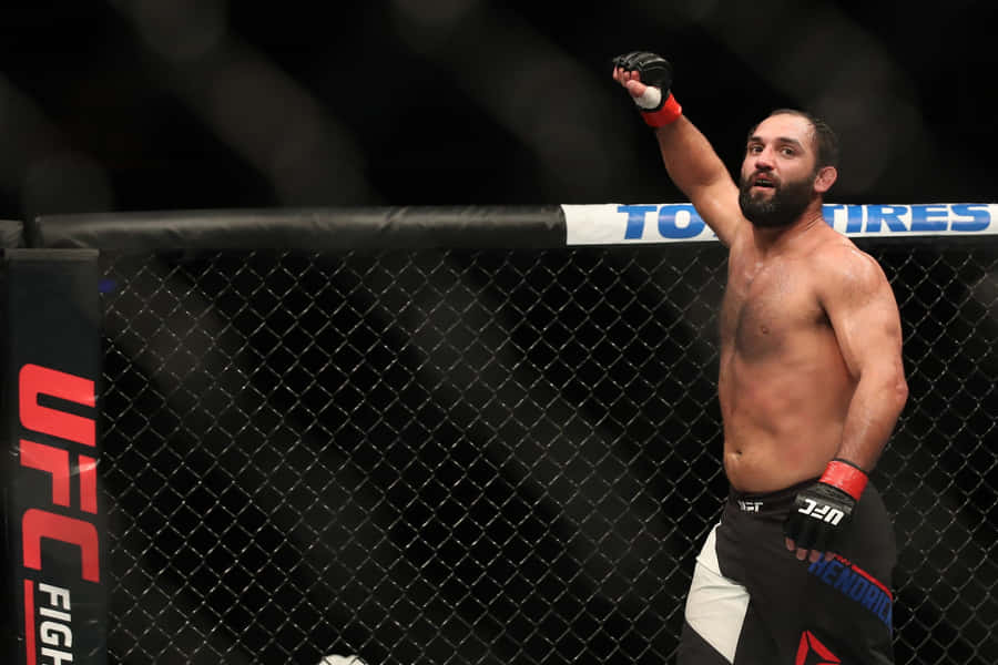 Mma Fighter Johny Hendricks Raising His Fist In Celebration Wallpaper