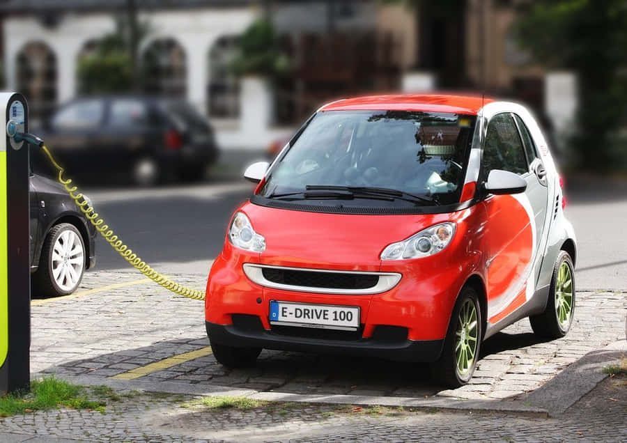 Modern Electric Vehicle Charging At A Station Wallpaper