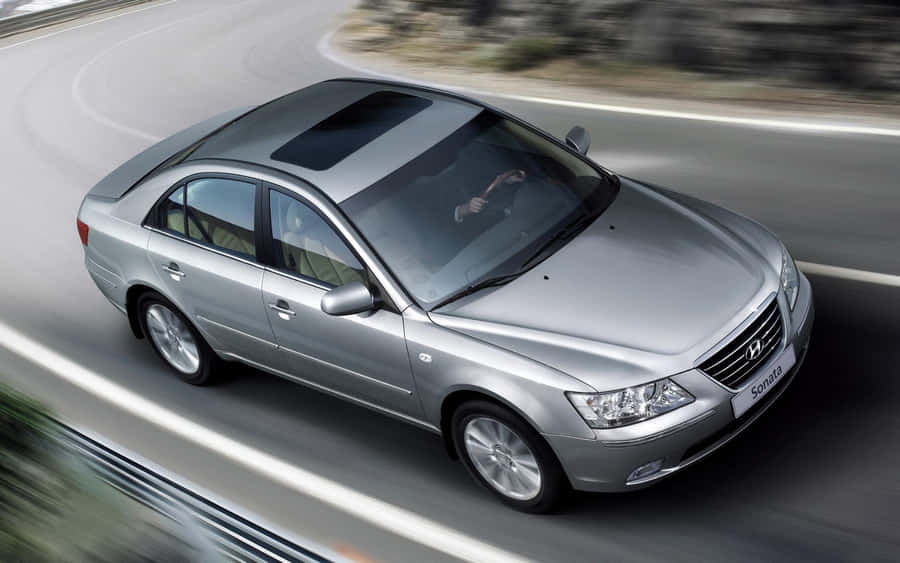 Modern Hyundai Sonata On A Stunning Scenic Road Wallpaper