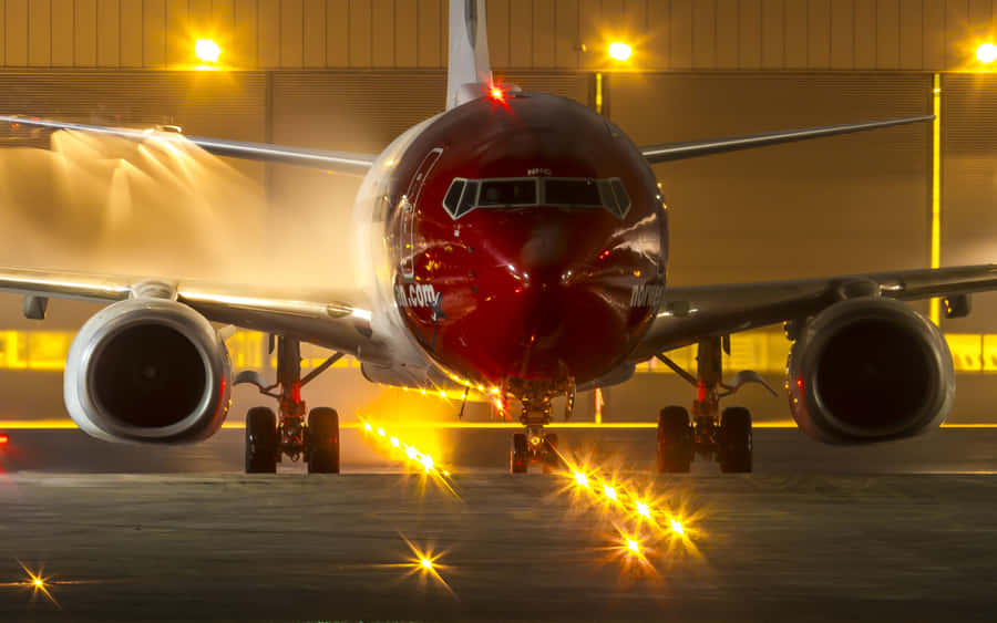 Modern Passenger Aircraft Flying Through The Sky Wallpaper