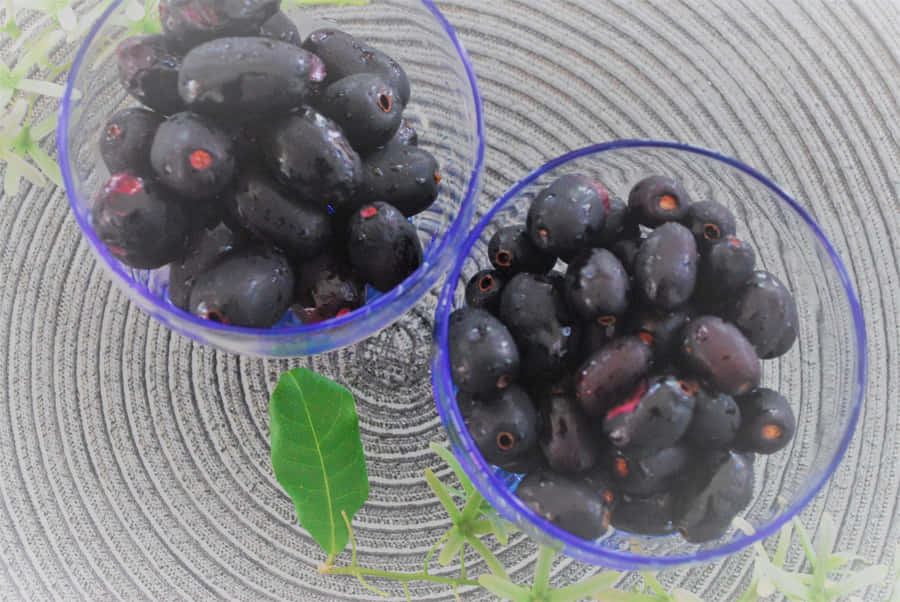 Moist Java Plums In Transparent Containers Wallpaper