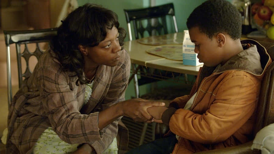 Mother Comforts Son Scene Wallpaper