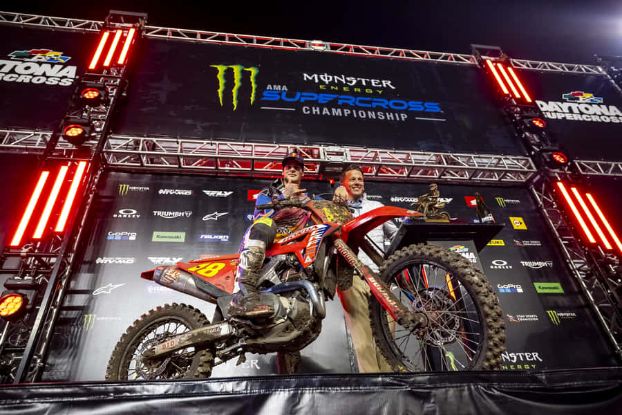 Motocross Champion Celebrationat Night Wallpaper
