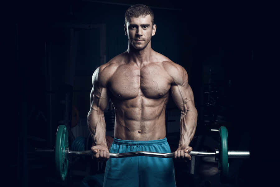 Muscular Man Performing Bicep Curls Wallpaper