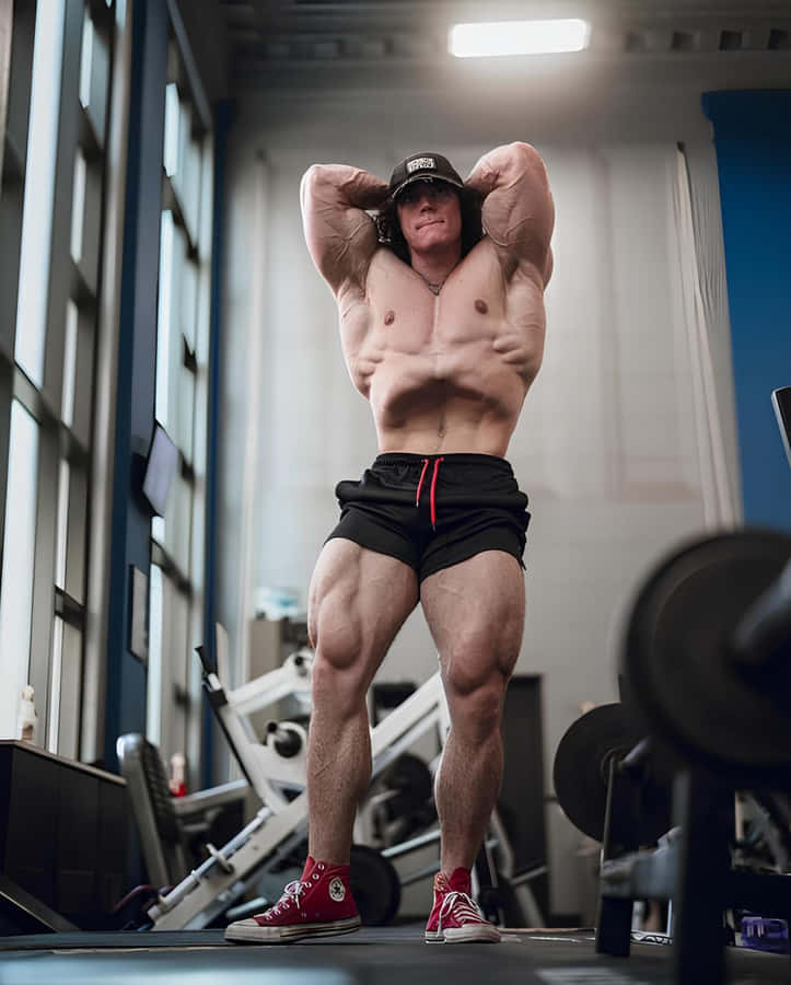 Muscular Man Posingin Gym Wallpaper