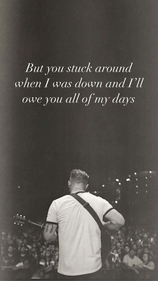 Musicianon Stagewith Inspirational Quote Wallpaper