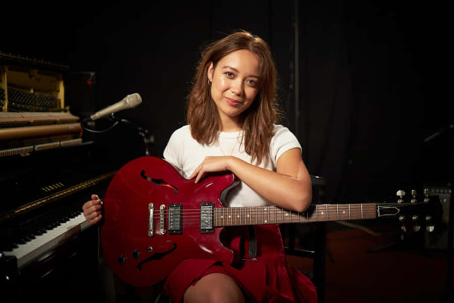 Musicianwith Red Guitarin Studio Wallpaper