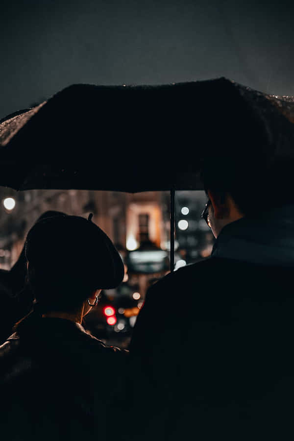 Mysterious Couple Under Umbrella Wallpaper