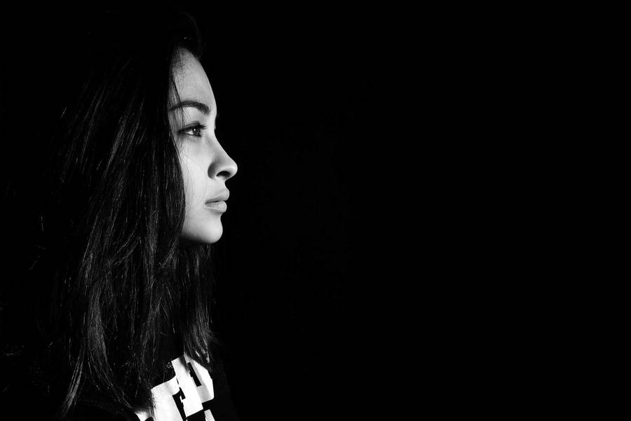 Mysterious Dark-haired Girl Gazing To The Right Wallpaper