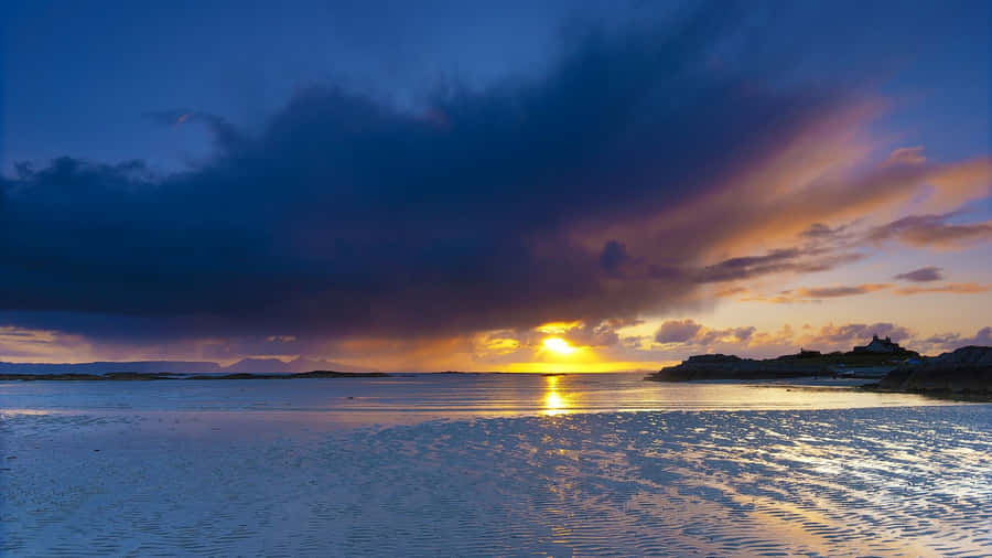 Mysterious Dark Island Under A Stormy Sky Wallpaper