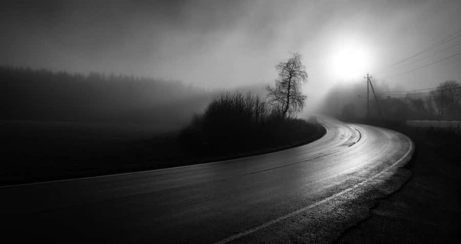 Mysterious Dark Road Under A Night Sky Wallpaper