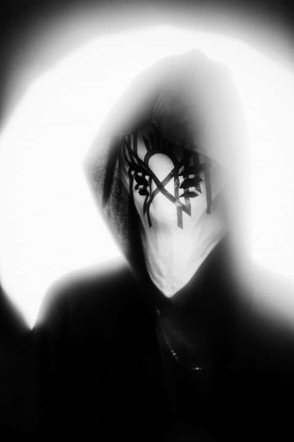 Mysterious_ Figure_with_ Masked_ Face Wallpaper