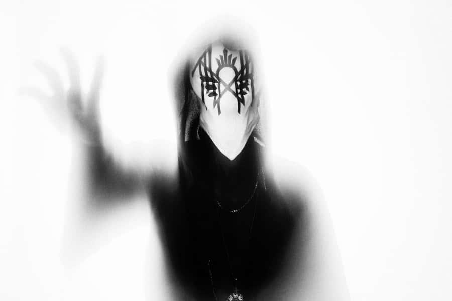 Mysterious_ Figure_with_ Symbolic_ Mask Wallpaper