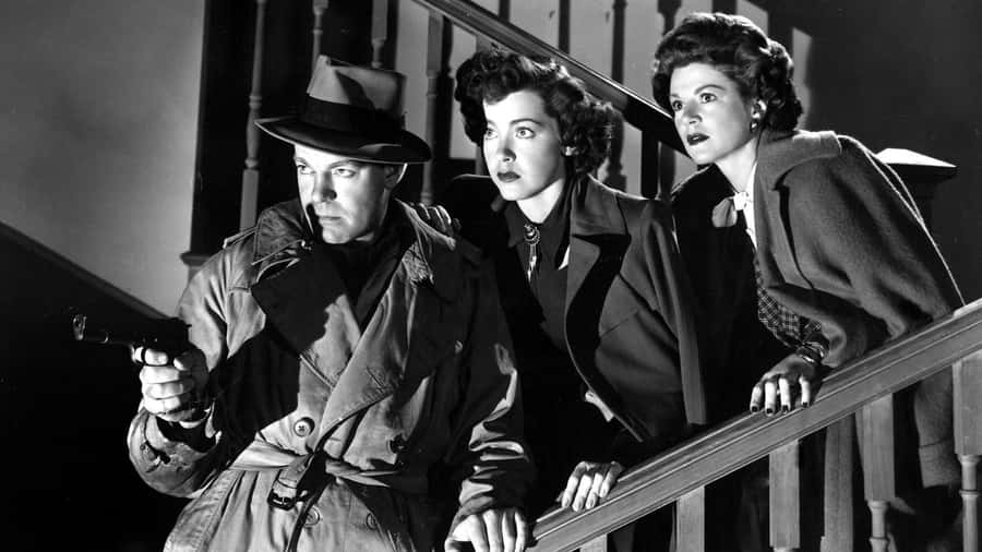 Mysterious Silhouette In A Dark Alley During A Rainy Night In The Film Noir Era Wallpaper